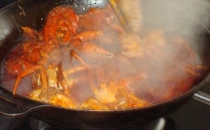 Steaming wok of chilli crab